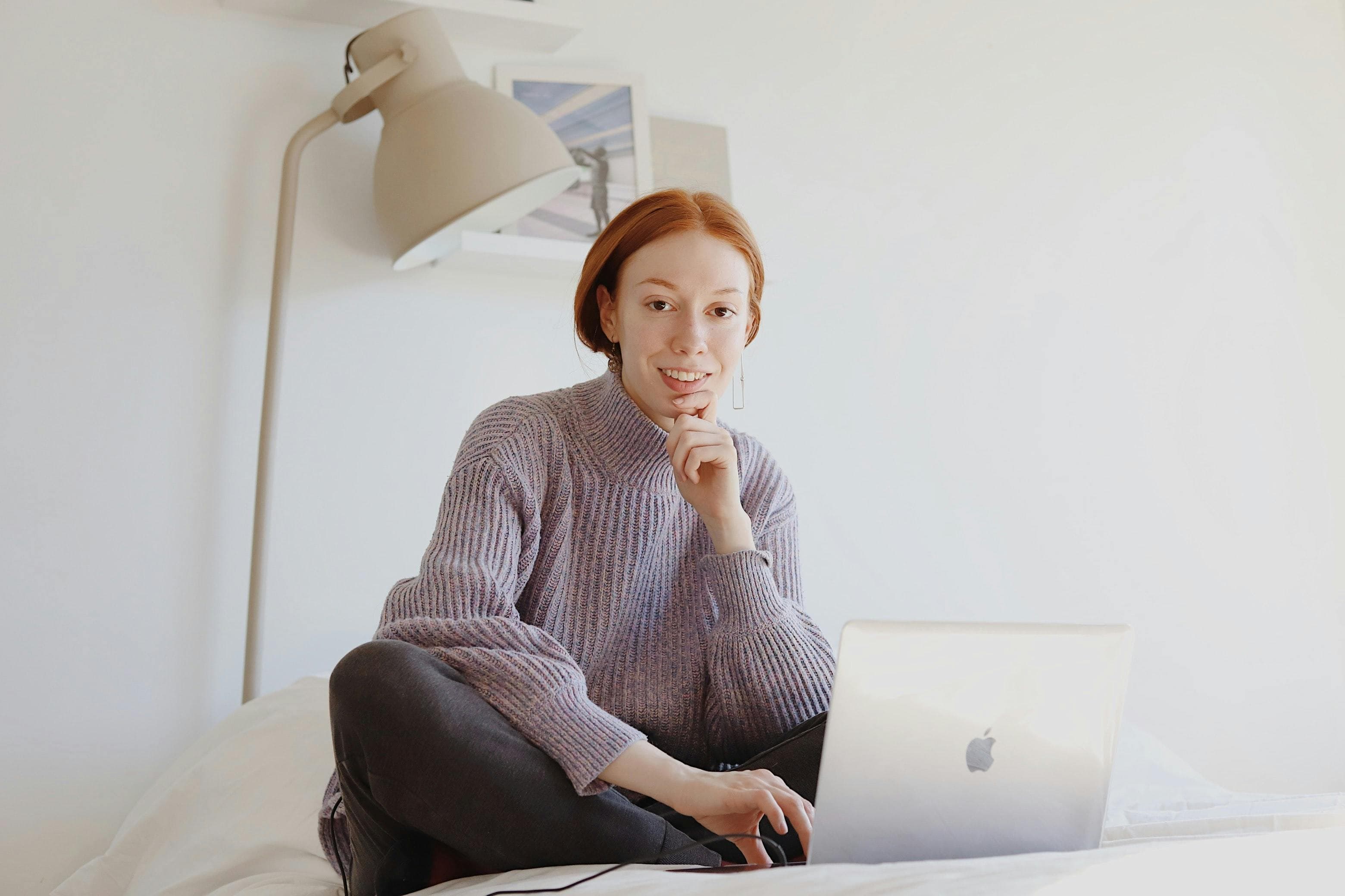 Freelancer on laptop in white room