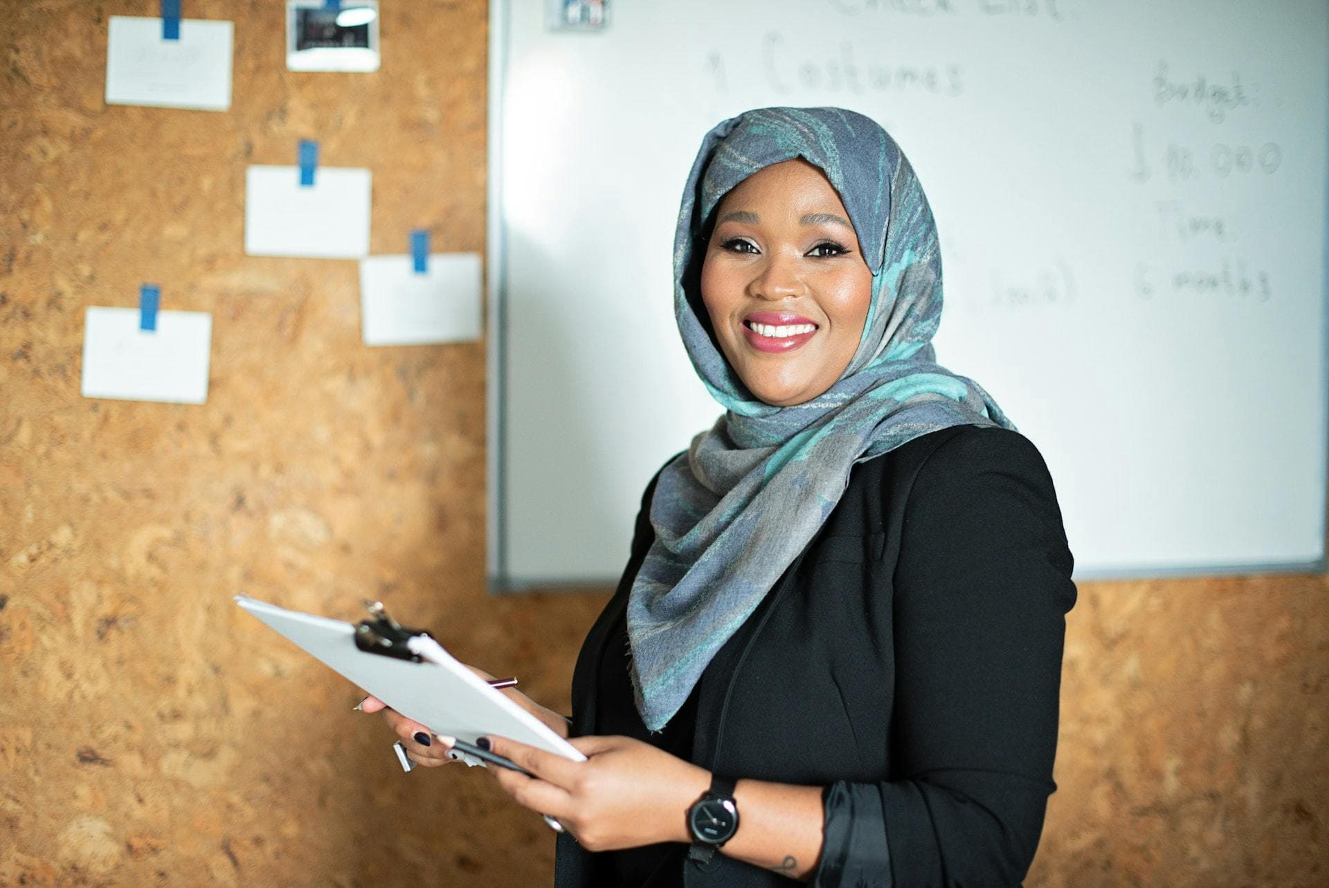 Female business owner in hijab in front of a whiteboard