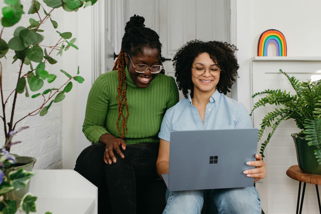 Two freelancers smiling at a laptop